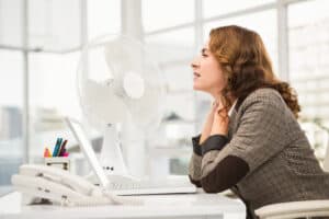 casual businesswoman being cooled by ventilator